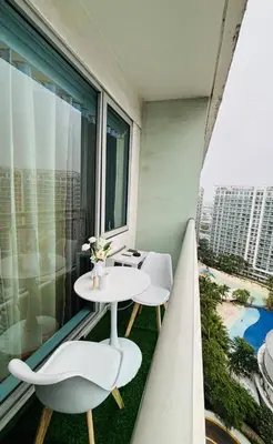 a balcony with a table and chairs on a building at Mhax's Place - Azure Parañaque in Manila