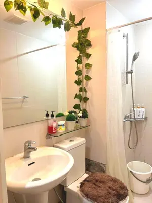 a bathroom with a sink and a toilet and a mirror at Mhax's Place - Azure Parañaque in Manila