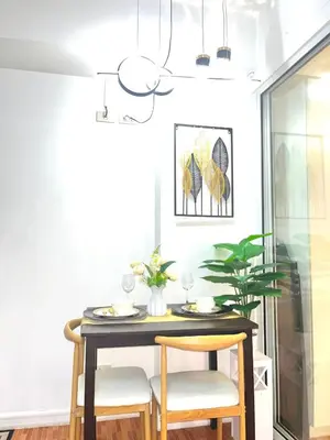 a dining room with a table and two chairs at Mhax's Place - Azure Parañaque in Manila