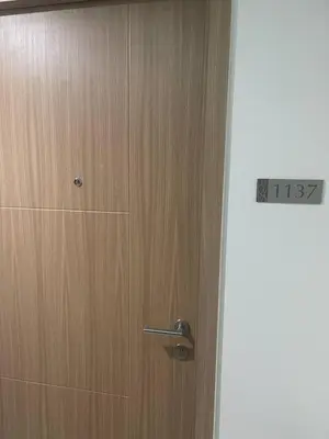 a wooden door with a temperature sign on it at Red Residences Chino Roces Makati in Manila