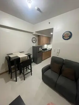 a living room with a couch and a table at Red Residences Chino Roces Makati in Manila