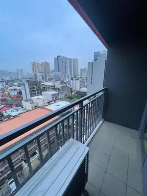 a balcony with a bench and a view of a city at Red Residences Chino Roces Makati in Manila