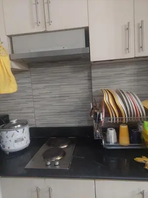 a kitchen counter top with a stove and some dishes at 2BR SEA RESIDENCES By ELSIE D in Manila