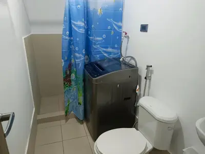 a bathroom with a toilet and a shower curtain at Happy Stays D - 300mbps - 65