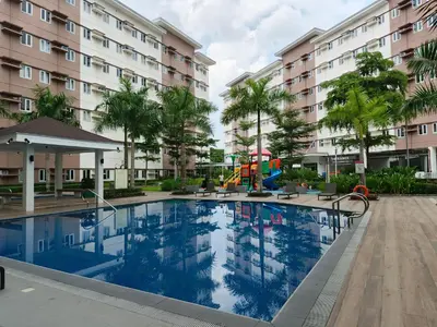 a swimming pool with a playground in front of a building at Happy Stays D - 300mbps - 65