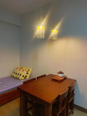 a dining room with a table and a couch at Happy Stays D - 300mbps - 65