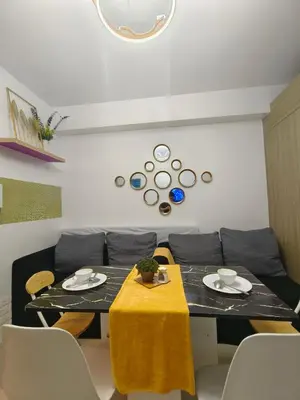 a living room with a table and a couch at Pasay Shore Residences Staycation in Manila