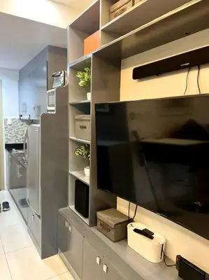a kitchen with a large entertainment center with a television at Casa Cintores Condo near PICC with FREE parking in Manila
