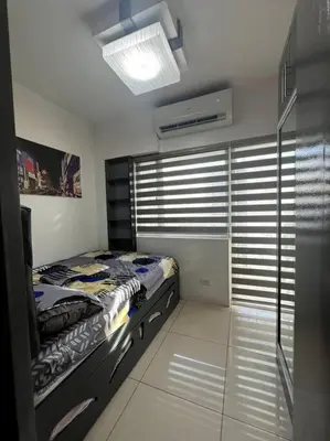 a bedroom with a bed in a room with windows at Casa Cintores Condo near PICC with FREE parking in Manila