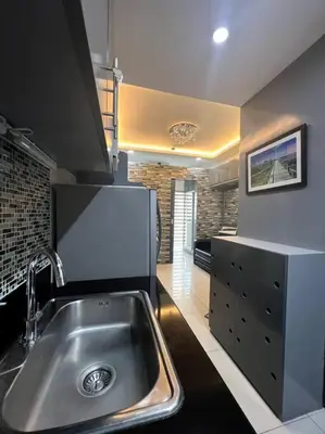 a kitchen with a stainless steel sink in a room at Casa Cintores Condo near PICC with FREE parking in Manila