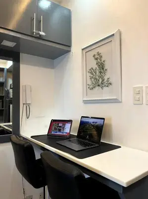 two laptop computers sitting on a counter in a kitchen at Casa Cintores Condo near PICC with FREE parking in Manila