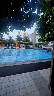 a large swimming pool with a city in the background at Uno - Condo Unit in SM Jazz Residences in Manila