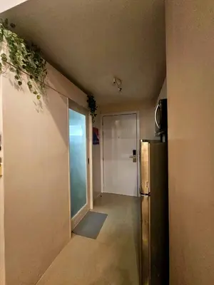 an empty hallway with a refrigerator and a door at Uno - Condo Unit in SM Jazz Residences in Manila