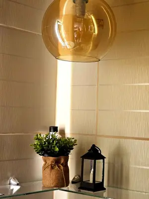a light hanging over a counter with a potted plant at Uno - Condo Unit in SM Jazz Residences in Manila