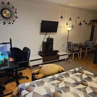 a living room with a dog laying on the floor at Mench Staycation in Manila