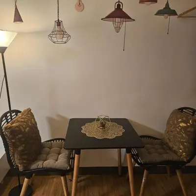 a dining room with a table and two chairs at Mench Staycation in Manila
