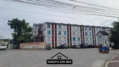 a large apartment building with a sign in front of it at Modern 2BR Condo with Terrace,Netflix,Pool,& WiFi in Imus