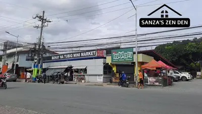 a street corner with a street sign in front of a store at Modern 2BR Condo with Terrace,Netflix,Pool,& WiFi in Imus