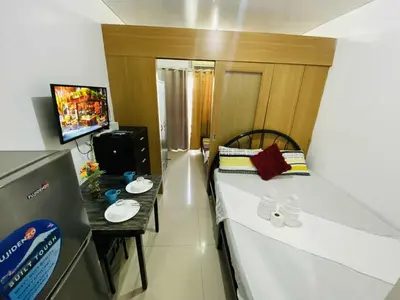 a small room with a bed and a table at SD 2 staycation in Manila