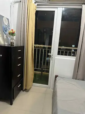 a bedroom with a window and a bed and a dresser at SD 2 staycation in Manila
