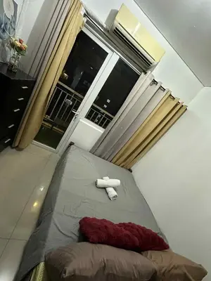 a bed with a stuffed animal on it in a bedroom at SD 2 staycation in Manila