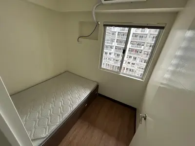 a small room with a bed and a window at blue sky viewing in Manila