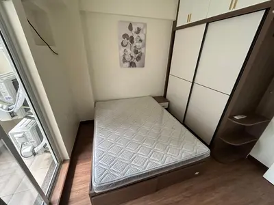 a small bedroom with a bed in a room at blue sky viewing in Manila