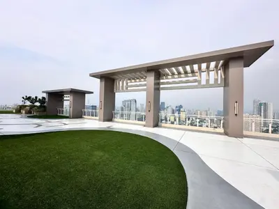a view from the roof of a building with a green lawn at blue sky viewing in Manila