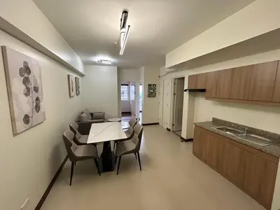 a kitchen and living room with a table and chairs at blue sky viewing in Manila