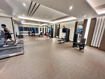 a person running on a treadmill in a gym at blue sky viewing in Manila