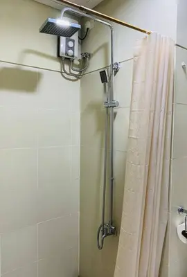 a shower in a bathroom with a shower curtain at 1 Bedroom with Balcony near Mall of Asia in Manila