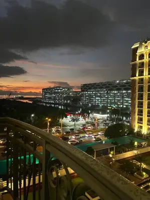 a view of a city at night with buildings at Cozy 1-BR Retreat Near MOA Pool view in Manila