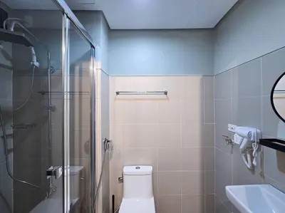 a bathroom with a shower and a toilet and a sink at 1BR Condotel with Balcony at FAME Residences #FM56 in Manila