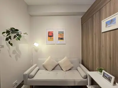 a living room with a couch and a table at 1BR Condotel with Balcony at FAME Residences #FM57 in Manila