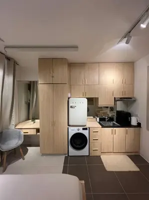 a kitchen with a stove and a refrigerator in it at Chic & Cozy Apartment Near BGC with Home Theater Setup in Manila