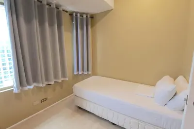 a small room with a bed and a window at Alpha Grandview Malate Condo 2004 in Manila