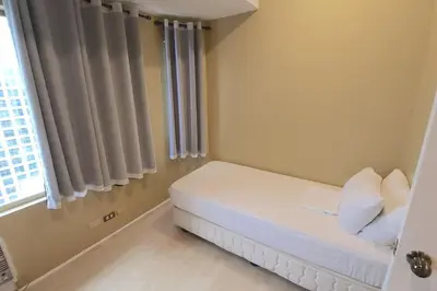 a small room with a bed and a window at Alpha Grandview Malate Condo 2004 in Manila