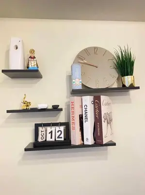a shelf with a clock and books on a wall at Easy Escape 1bedroom unit Satori Pasig in Manila