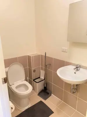 a bathroom with a toilet and a sink at Easy Escape 1bedroom unit Satori Pasig in Manila