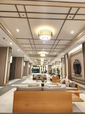 a large lobby with couches and a television in it at Easy Escape 1bedroom unit Satori Pasig in Manila