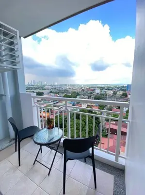 a balcony with a table and chairs and a view at Easy Escape 1bedroom unit Satori Pasig in Manila