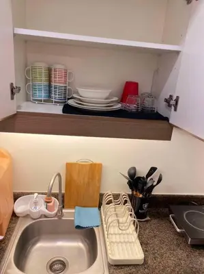a kitchen counter with a sink in a kitchen at Easy Escape 1bedroom unit Satori Pasig in Manila
