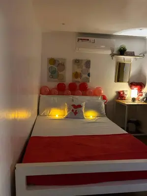 a bedroom with a red and white bed with balloons on it at A private house with swimming pool- Unit1 in Kawit