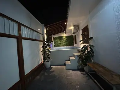 a hallway with potted plants and a window in a building at A private house with swimming pool- Unit1 in Kawit