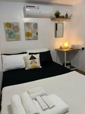 a bedroom with a white bed with a desk and a bed sidx sidx sidx at A private house with swimming pool- Unit1 in Kawit