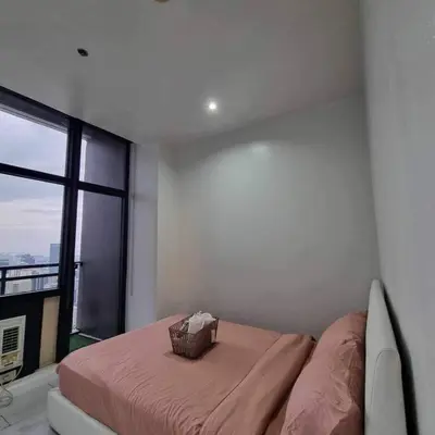 a bedroom with a bed with a basket on it at Cozy Two Bedroom Flat in The Gramercy Residences in Manila