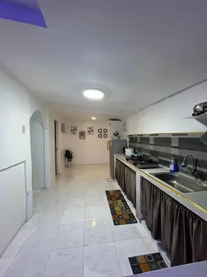 a kitchen with a sink and a counter top at ACL Staycation Home in Imus & Kawit with portable pool unit 2 in Kawit