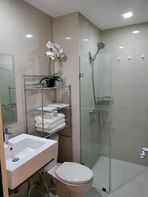 a bathroom with a toilet and a sink and a shower at The Nest C5-7F EightyOne Newport Boulevard Condominium, Pasay City in Manila