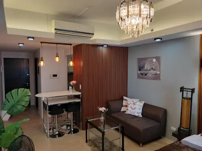 a living room with a couch and a table at The Nest C5-7F EightyOne Newport Boulevard Condominium, Pasay City in Manila