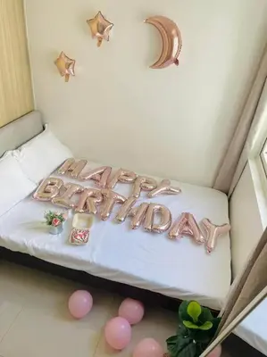 a happy birthday sign on a bed in a room at Condo at Shore 1 with Netflix in Manila